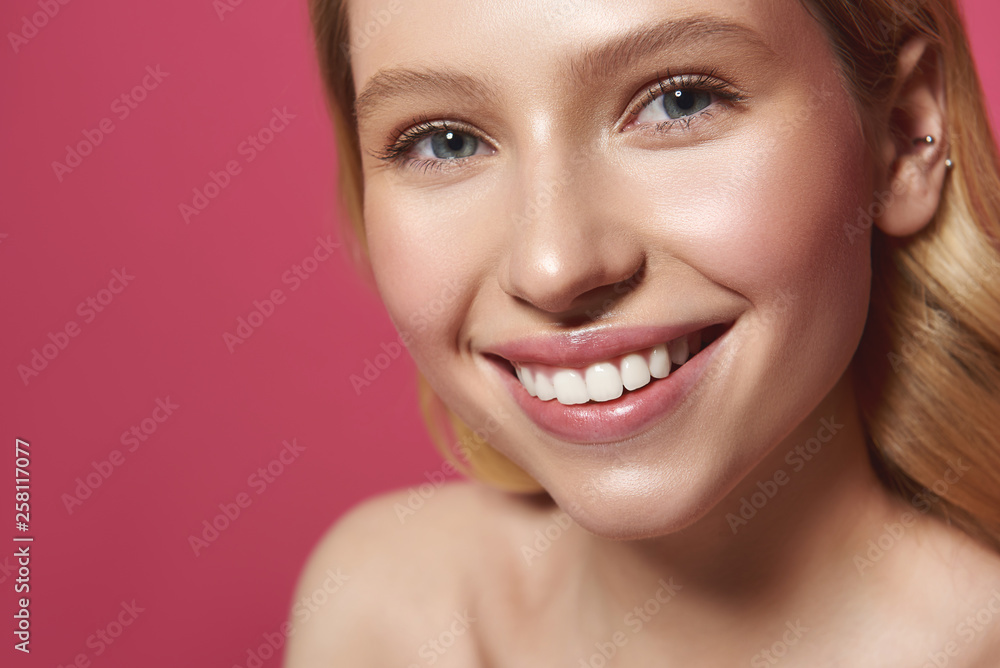 Sincerely smiling blonde woman isolated on pink Sincerely smiling blonde woman isolated on pink