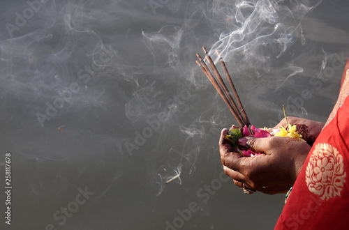 Hindu woman pray sun God, with food offerings, at dusk,in the bank of lake, during annual ritual Chhath Puja photo