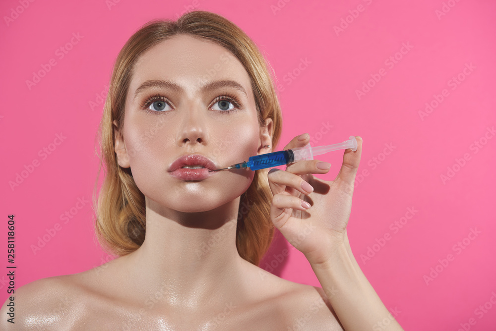 Young blonde female having lips filler injection Young blonde female having lips filler injection