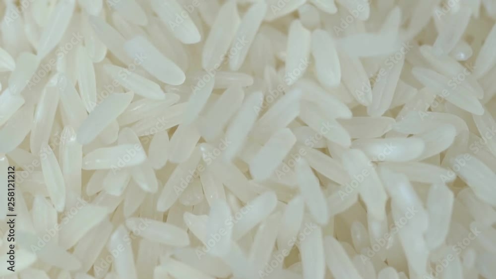 Closeup jasmine white rice, Uncooked products by organic natural food concept, Top view, Slow Motion footage Closeup jasmine white rice, Uncooked products by organic natural food concept, Top view, Slow Motion footage