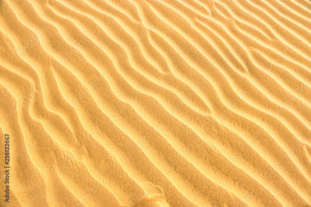 Texture of yellow desert sand dunes. Can be used as natural background Texture of yellow desert sand dunes. Can be used as natural background