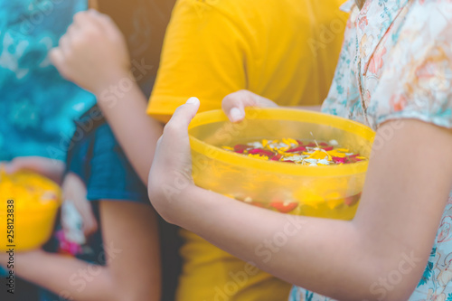 People are holding a bowl of water perfume with flower preparing to shower for the monks on Songkran day.(Thailand New Year)