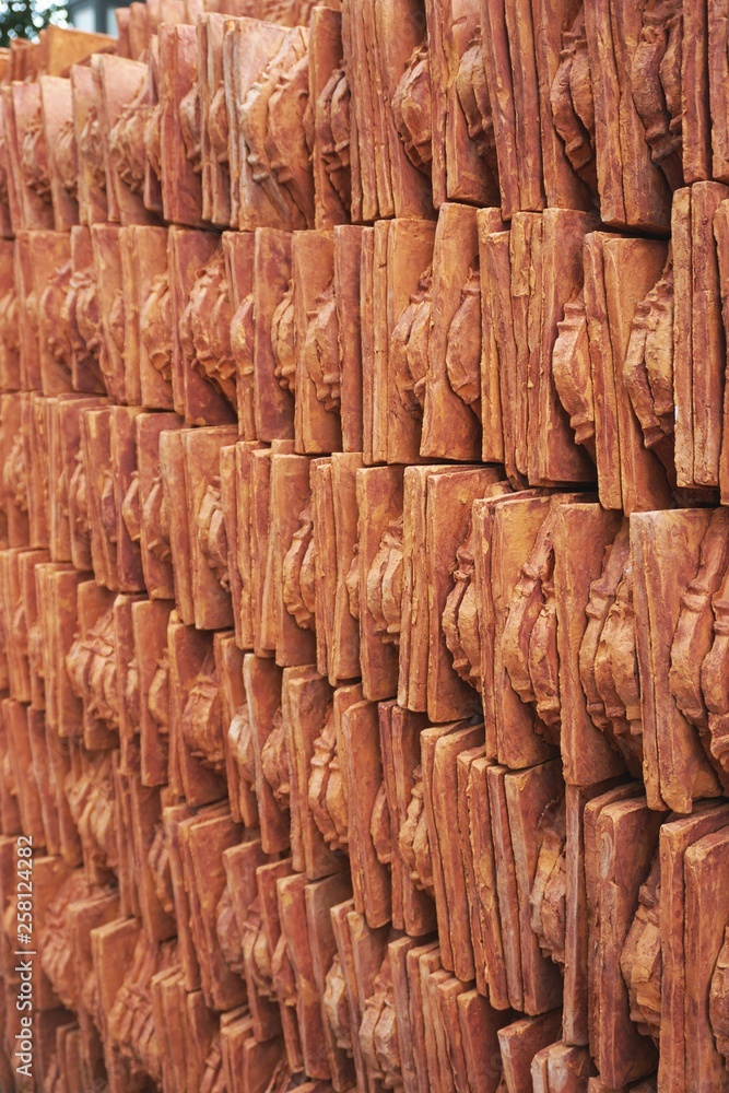 Rows of neatly stacked terracotta clay roof tiles in rural Vietnam
