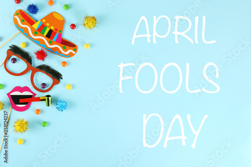 All fools day background concept with holiday accessories, April 1st themed party attributes. Close up, copy space, top view, flat lay.