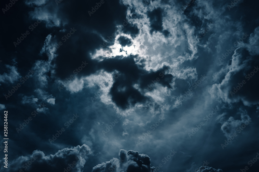 Moonlight shines behind a cloudy at night. serenity nature background.