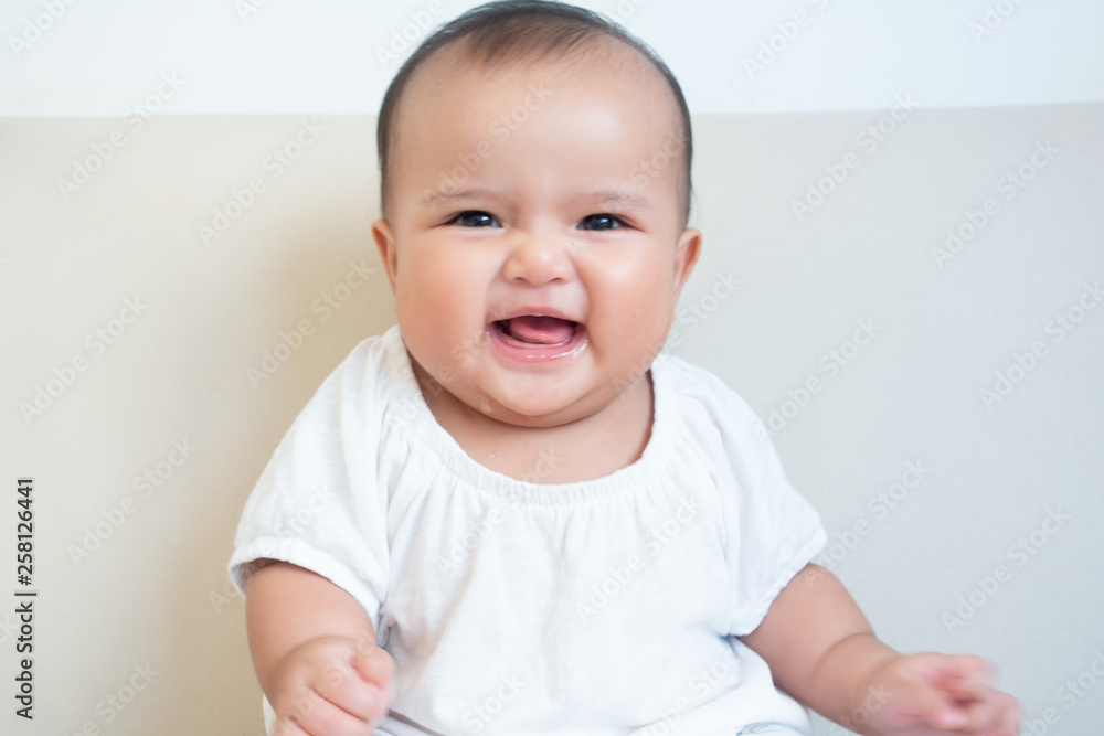 Asian baby girl making happy facial expression