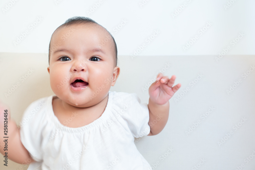 Asian baby girl making facial expression of happiness Asian baby girl making facial expression of happiness