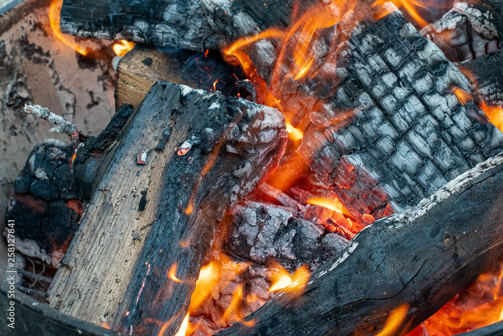 Glowing fire on cracked logs in a fire pit outdoors ~FIRESIDE~ Glowing fire on cracked logs in a fire pit outdoors ~FIRESIDE~