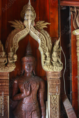 old wooden statue in a buddhistic temple