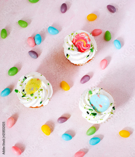 Easter vanilla cupcakes on pink background, top view