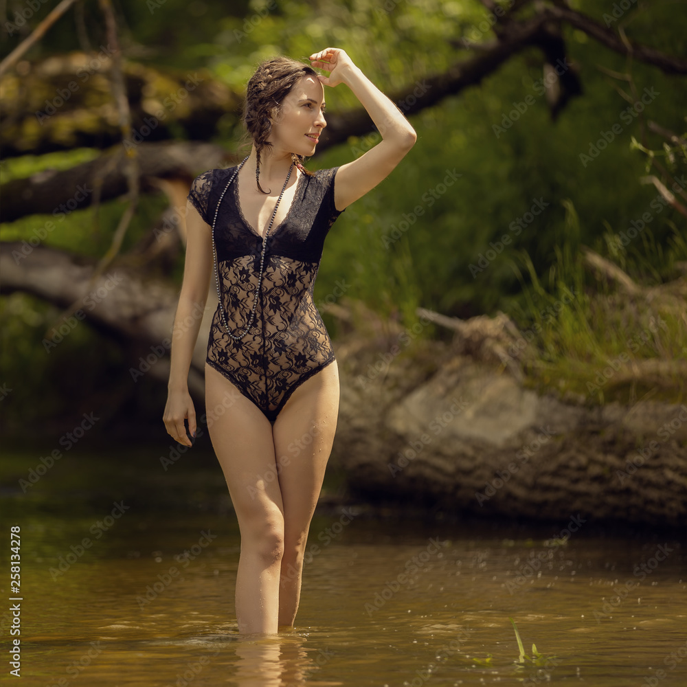 Girl in a bathing suit by the river Girl in a bathing suit by the river