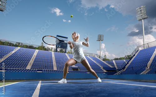 Beautiful female tennis player serving outdoor on professional tennis court. © VIAR PRO studio