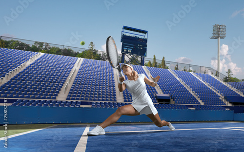 Beautiful female tennis player serving outdoor on professional tennis court. © VIAR PRO studio