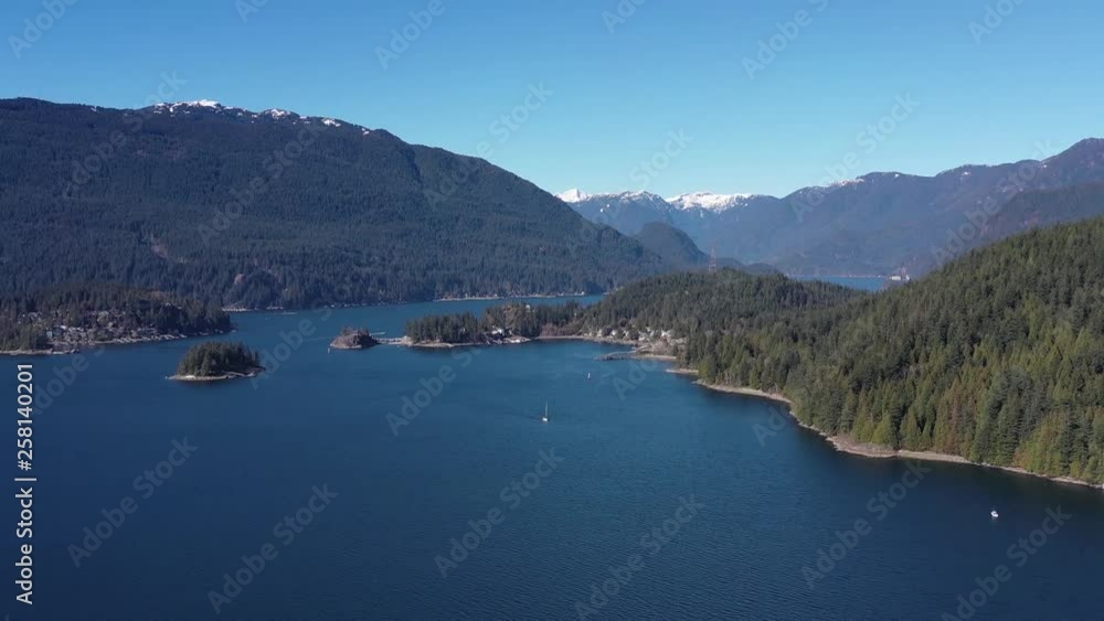Aerial view over Burrard Inlet, ocean and island with mountains in beautiful British Columbia. Canada. 4K. Aerial view over Burrard Inlet, ocean and island with mountains in beautiful British Columbia. Canada. 4K.