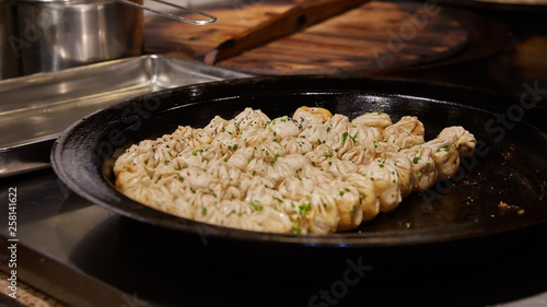 Photography big frying pan with sheng jian bao-traditional chinese pan fried dumplings with