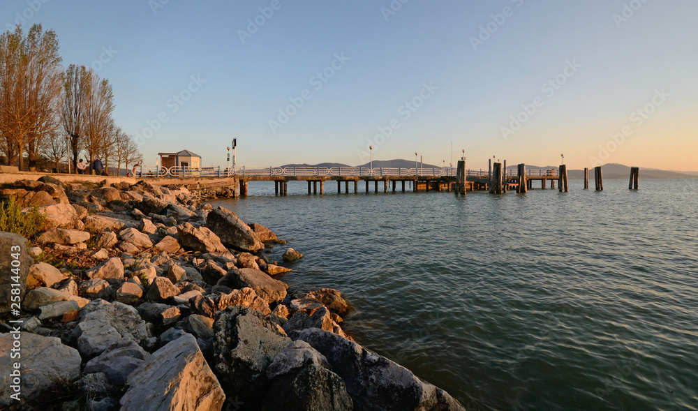 scenic view of a pier in the italian Trasimeno Lake on sunset