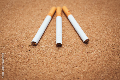 close up view of cigarettes on a brown background