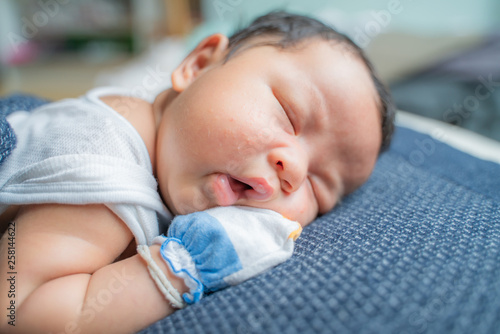 Adorable infant kid sleeping on blanket