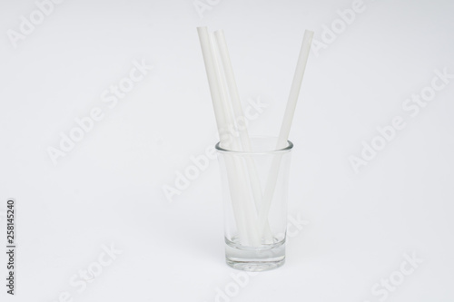 empty glass with colorful straws on a white background © Олег Кононов
