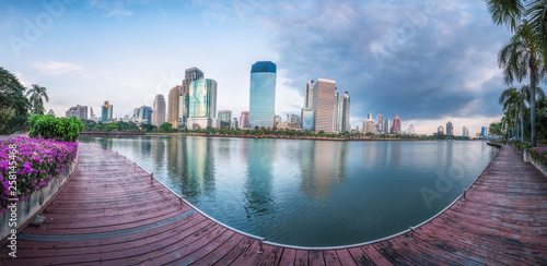 Panorama view of Benchakitti Park, Cityscape of skyscraper business reflection at Benchakitti park at twilight time in Bangkok, Thailand.