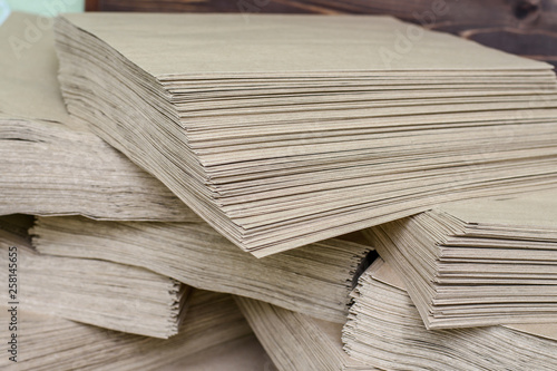 Side View Of Huge Stack of Recycled Paper close up. Business concept. Huge Stack of Recycled Paper envelopes closeup. Eco Kraft paper.