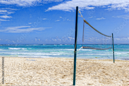 Volleyball net on a deserted sandy beach on the tropical sea.