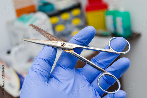 rusty scissors in the hand of a veterinarian