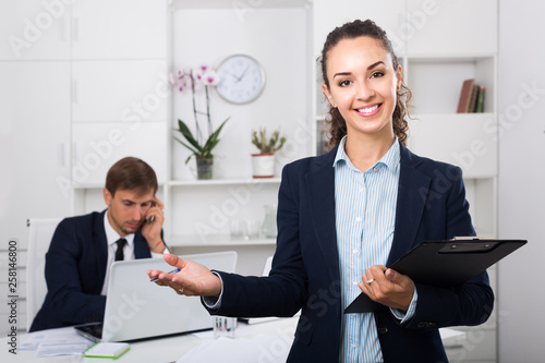 portrait of  business woman holding cardboard in office photo