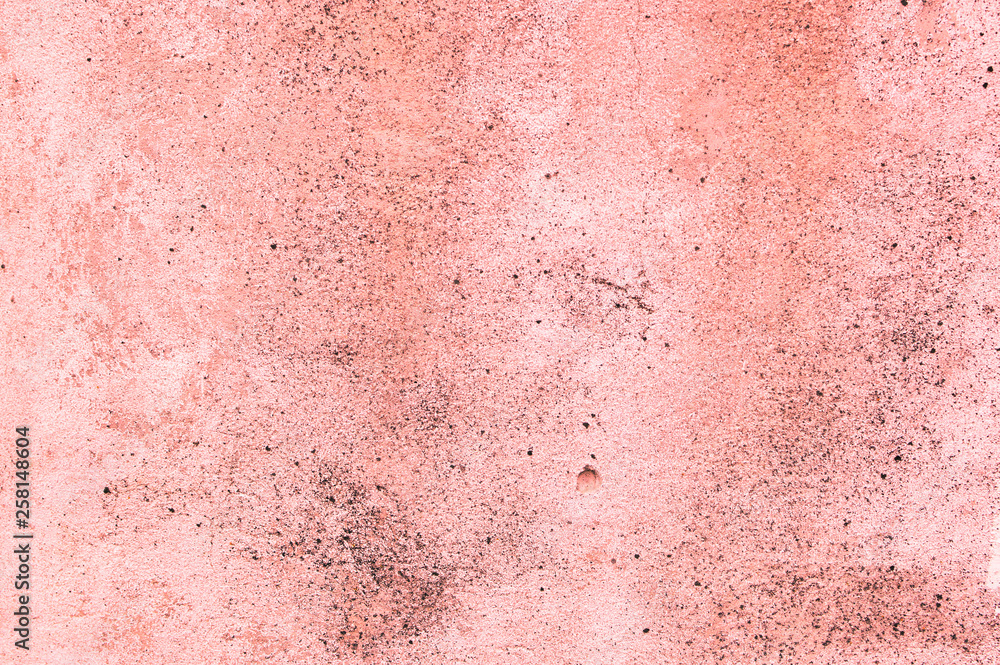 Living Coral color of the Year 2019 on abstract background or decorative texture of old stucco wall, plaster. Home decor.Patchy texture of rough concrete wall or  abstract plaster background.