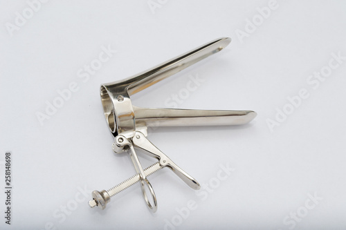 vaginal speculum on white surface