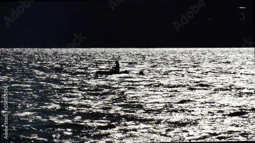 Lonely boat with a fisherman at night on the water