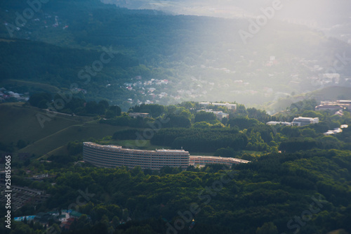 Sunset over Kislovodsk from a height in summer, the rays of the sun through the clouds.