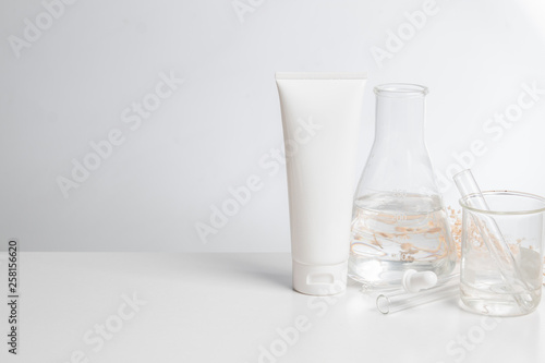 close up science medical chemical and treatment cream lotion aromatic beauty cosmetic skincare with test tube and mockup product on table white background