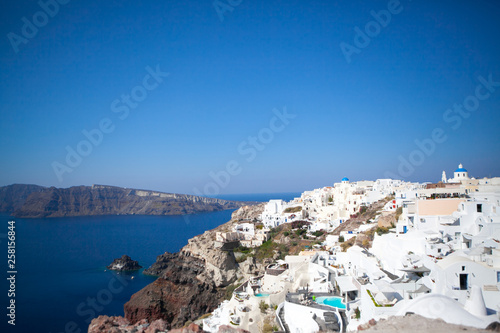 Oia town on Santorini island  Greece. Traditional and famous white houses and churches with blue domes over the Caldera