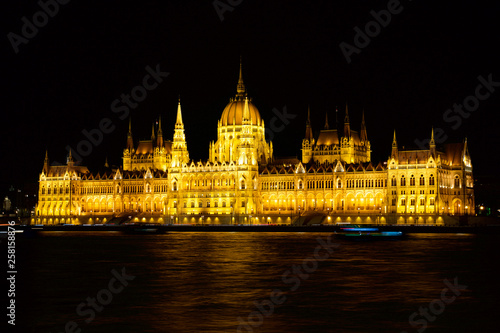 BUDAPEST, HUNGARY - MAR 07th, 2019: The Hungarian Parliament Building is the seat of the National Assembly of Hungary at the Danube river during night, one of Europe's oldest legislative buildings