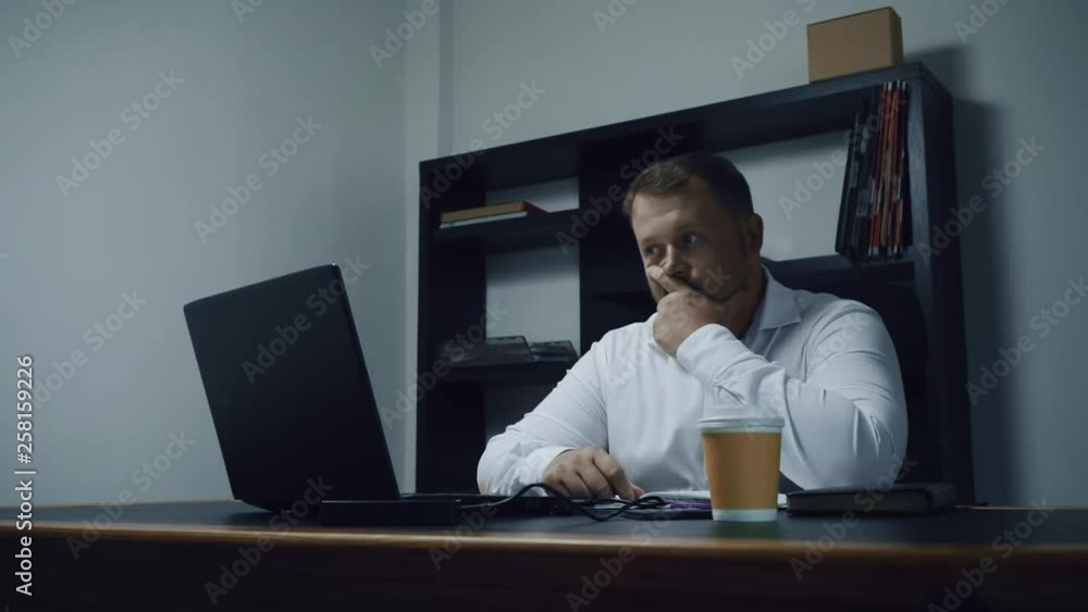 bearded businessman working in the office on the computer, male surprised and shocked, slow motion bearded businessman working in the office on the computer, male surprised and shocked, slow motion