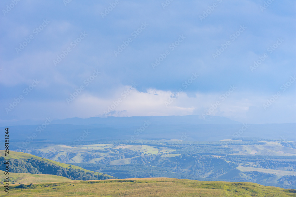 Overcast clouds in the distance over the hills Overcast clouds in the distance over the hills