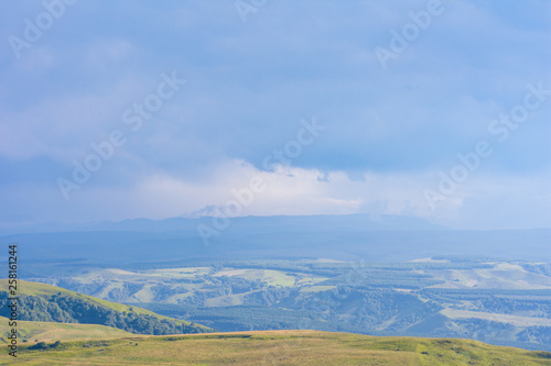Overcast clouds in the distance over the hills