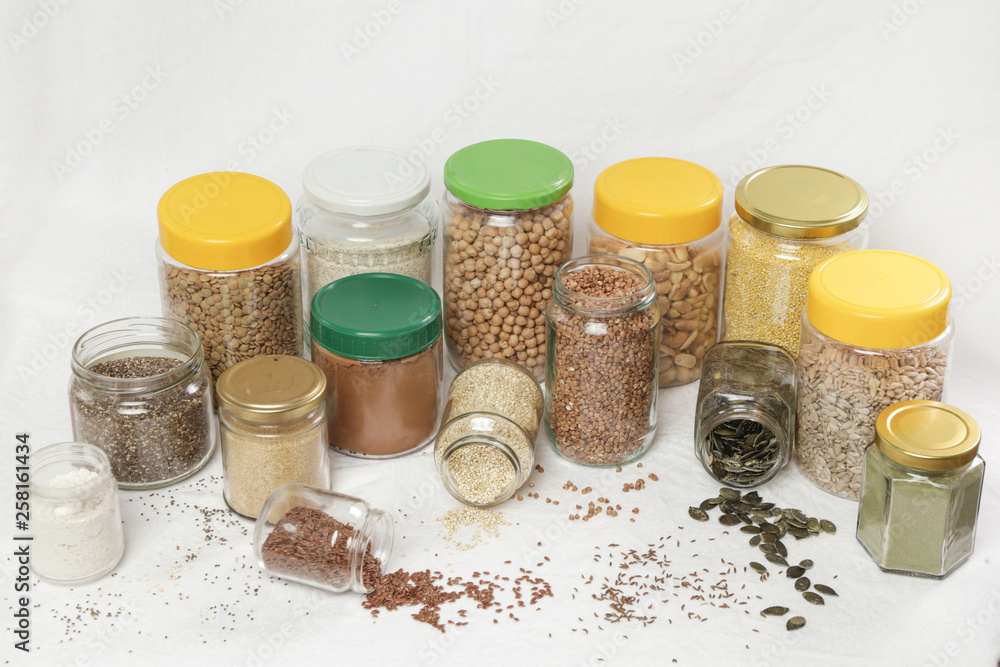 Top view of jars with grains, seeds, legumes, flours and various food ingredients. Healthy food concept. Top view of jars with grains, seeds, legumes, flours and various food ingredients. Healthy food concept.