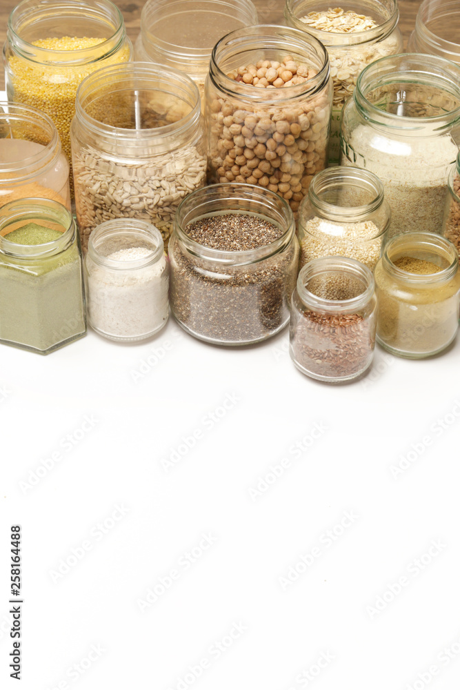 Top view of jars with grains, seeds, legumes, flours and various food ingredients. Healthy food concept. Top view of jars with grains, seeds, legumes, flours and various food ingredients. Healthy food concept.