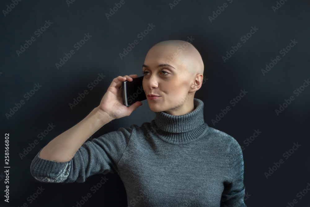 Beautiful bald girl talking on the phone.