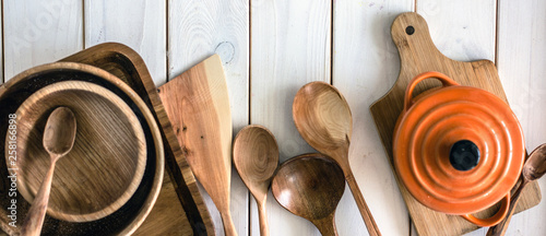 Kitchen utensils on wooden background. Kitchen utensils over wood background wooden table with copy space.Various wooden kitchen utensils on table top view with copy space. Culinary Background. 