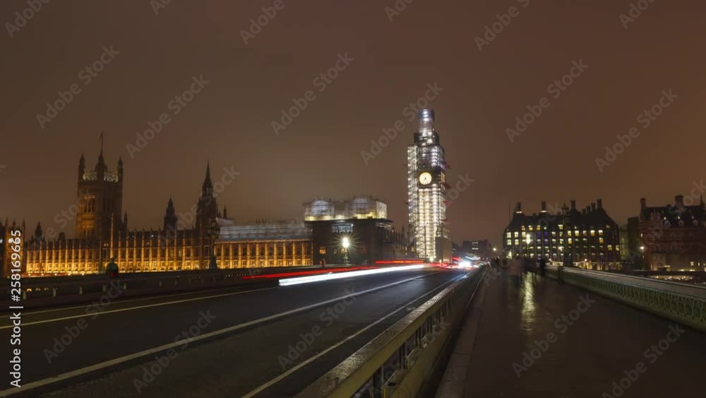 Big Ben time-lapse on the Westminster Bridge in London at Night , hyper lapse slow movement to the Big Ben. Long shutter speed with long light trails. Big Ben is under refurbishment.