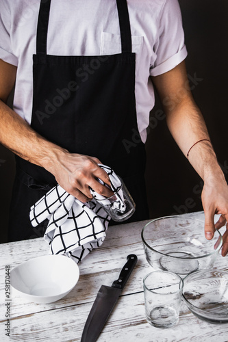 Waiter cleaning dishes. Restaurant stuff working, Male bartender.