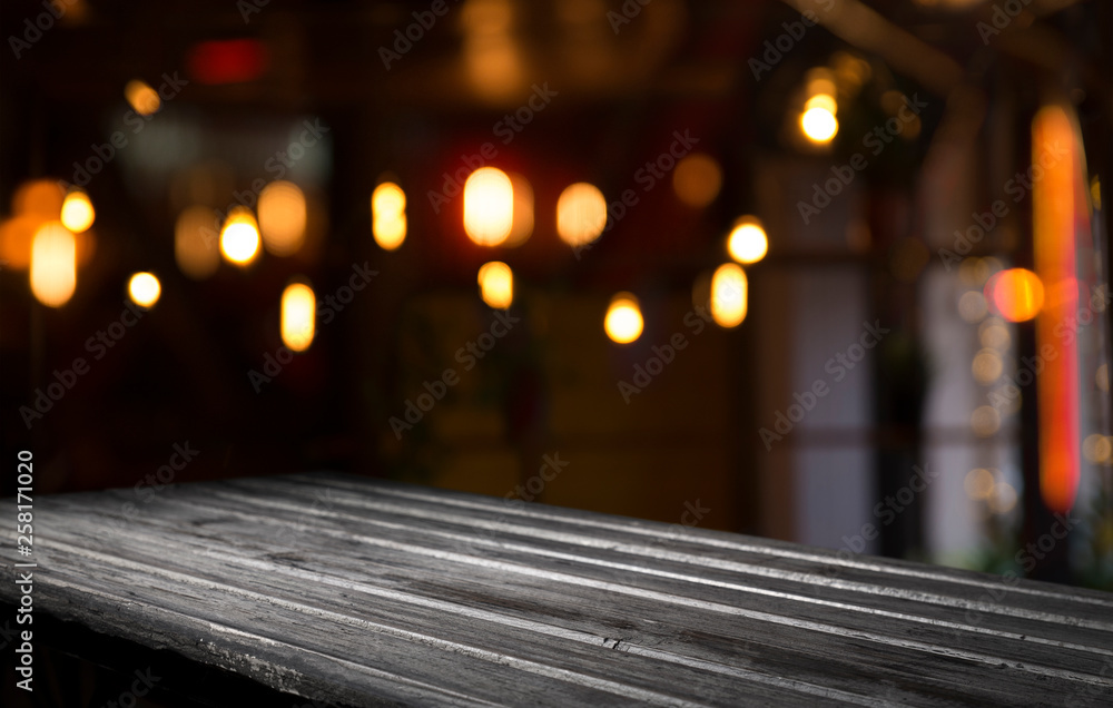 blurred background of bar and dark brown desk space of retro wood