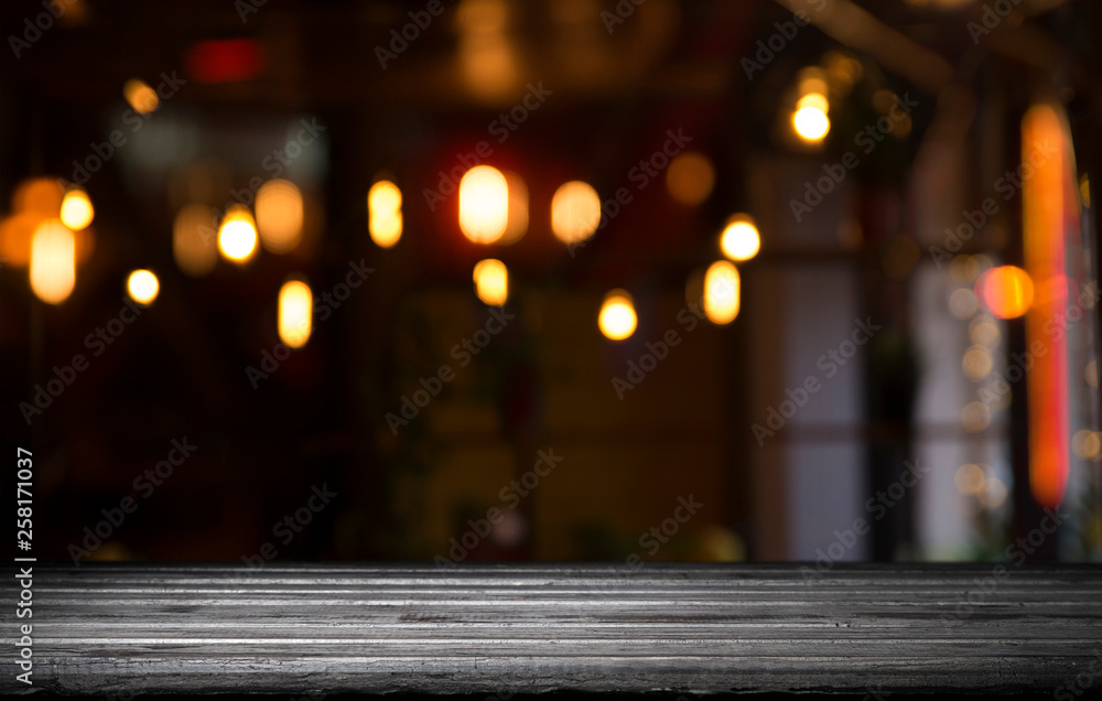 blurred background of bar and dark brown desk space of retro wood