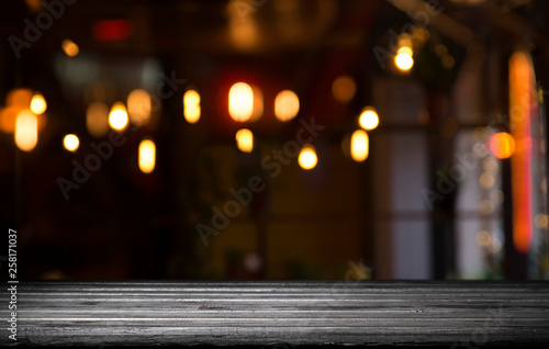 blurred background of bar and dark brown desk space of retro wood