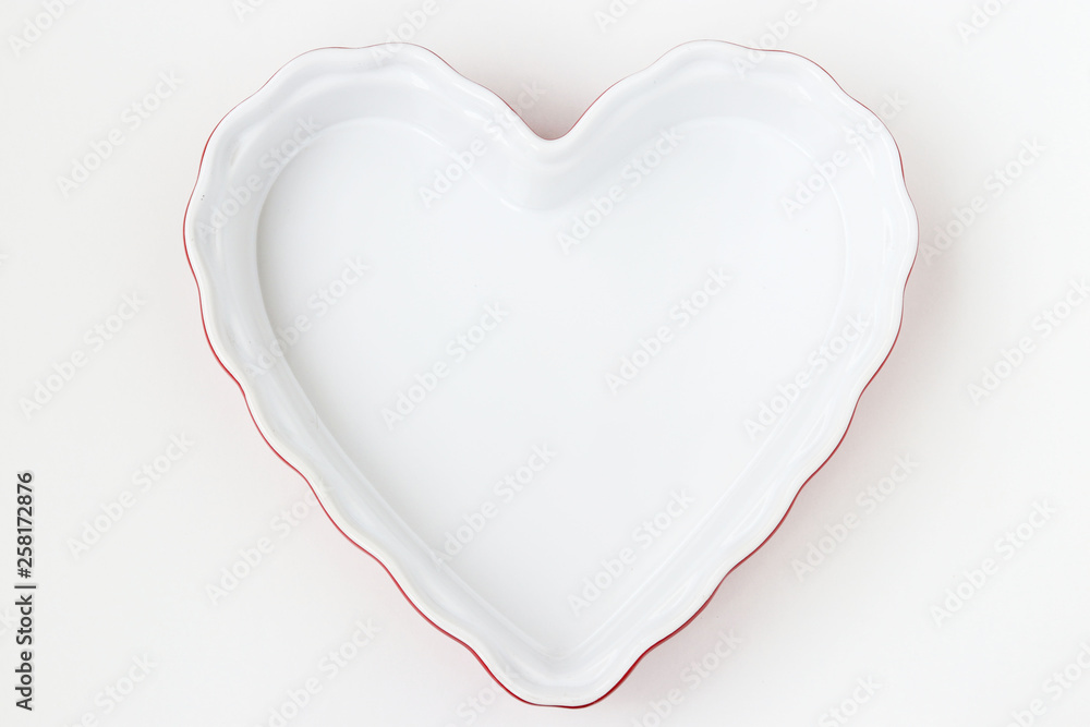 Ceramic form in the form of a heart is located on a white background
