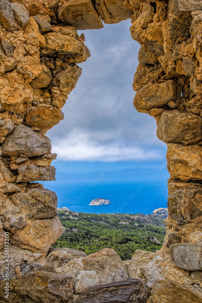 Monolithos knights castle overlooking the Mediterranean sea from hilltop. Rhodes, Greece. Monolithos knights castle overlooking the Mediterranean sea from hilltop. Rhodes, Greece.