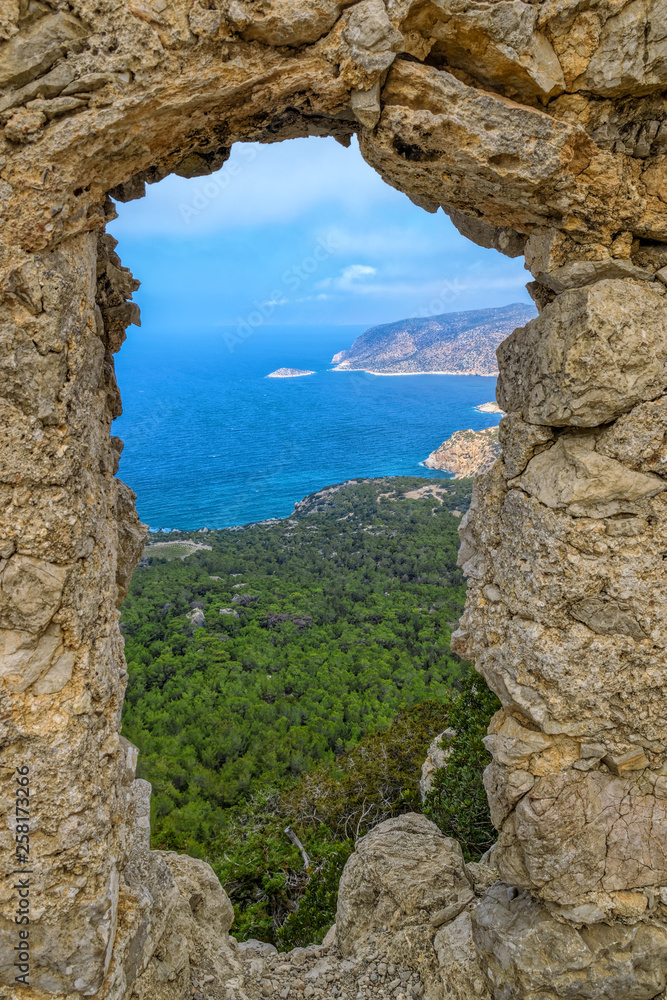 Monolithos knights castle overlooking the Mediterranean sea from hilltop. Rhodes, Greece. Monolithos knights castle overlooking the Mediterranean sea from hilltop. Rhodes, Greece.